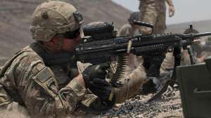 Firing a M249 light machine gun