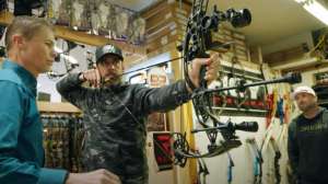 Aaron Rodgers shoots bow