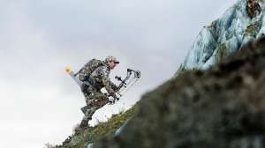 Bowhunter climbing