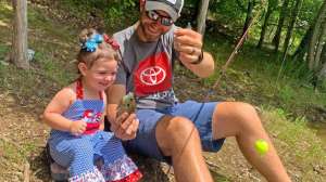 Brad Lester pro angler fishing with child photo Alan Mc Guckin