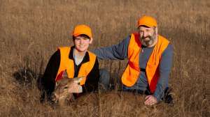 Deer hunters with doe