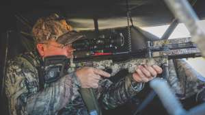 Fenson aiming Ten Point crossbow in blind