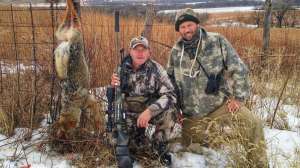 Mark Kayser and Kansas hunter Chad Serrault with coyote