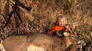 Little girl with buck and rifle