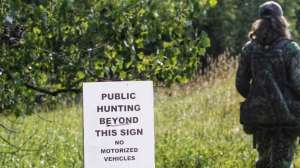 Public land hunter with sign
