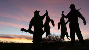 Successful coyote hunters at sunset700