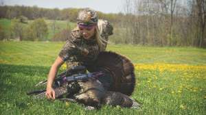 Women looking at dead turkey